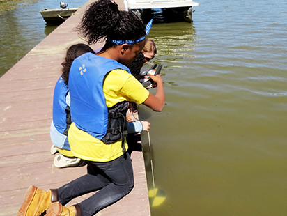 checking the clarity of the water from the dock